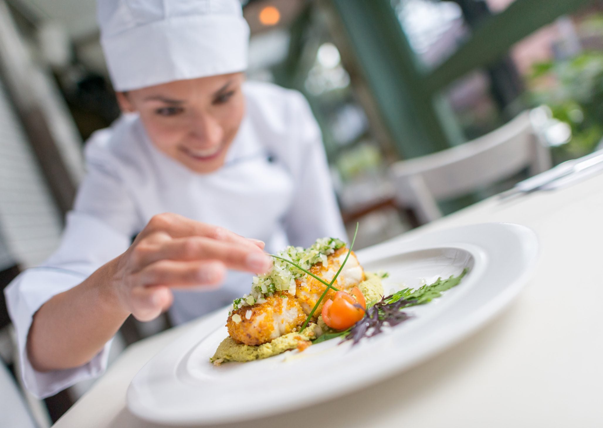 Close-up of a chef plating a MouCo cheese dish from the Fancy Recipes section, highlighting care, creativity, and culinary style.
