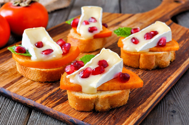 Toasted crostini topped with MouCo Camembert, sliced persimmons, pomegranate seeds, and a drizzle of honey—sweet, creamy bites for festive spreads or curious little snackers.