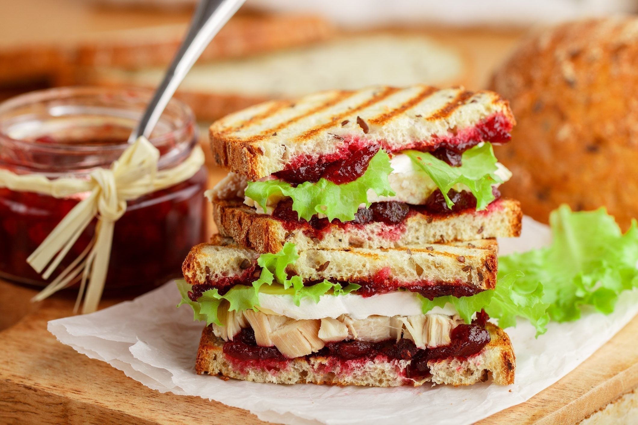 Golden toasted grain panini filled with MouCo Camembert, turkey, cranberry sauce, and crisp greens—a melty, savory-sweet upgrade for lunchboxes or grown-up brunches.