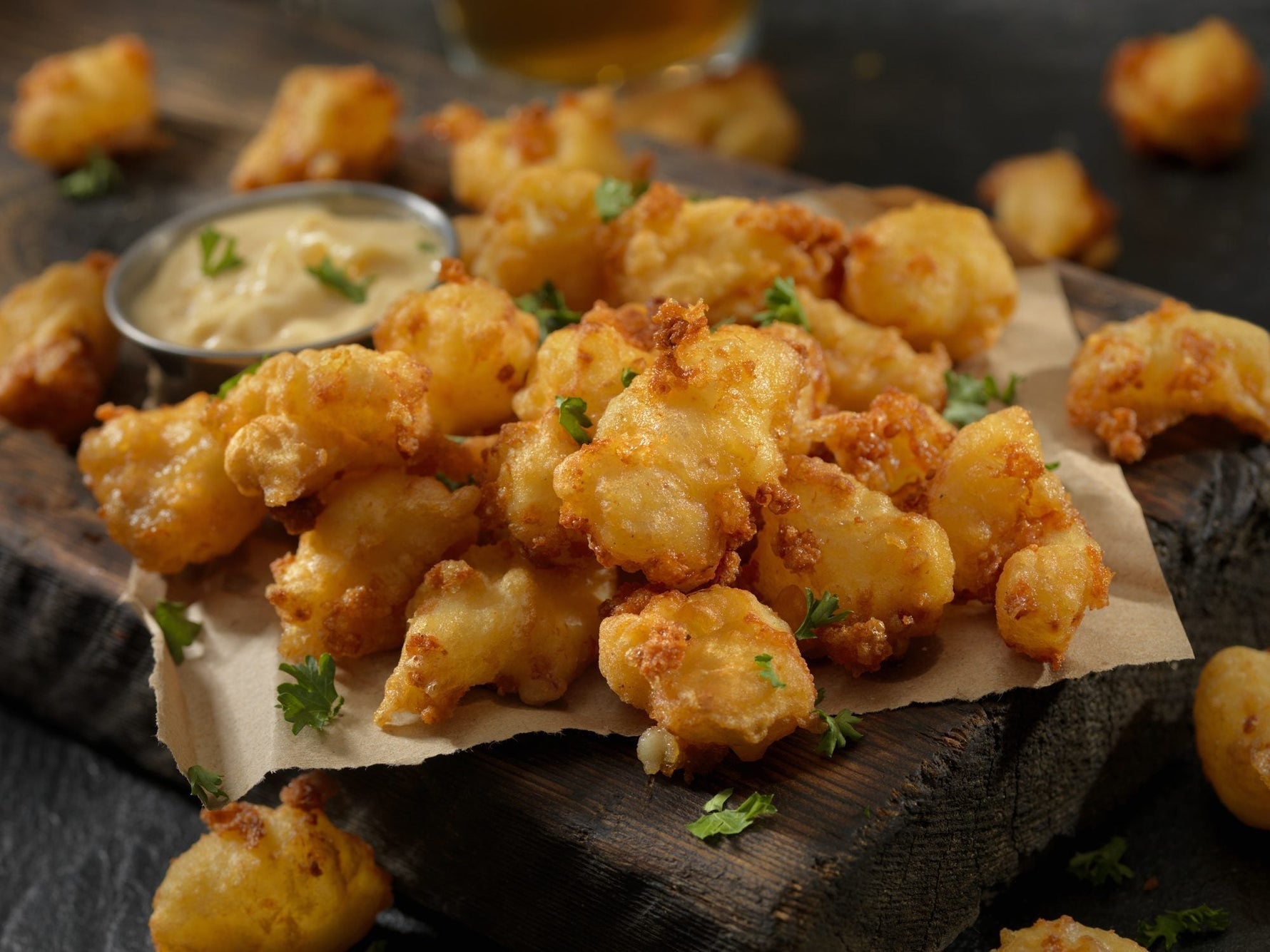 Golden-fried MouCo Cheddar Cheese Curds with crispy coating and gooey centers—an irresistible snack for cheese lovers of all ages.