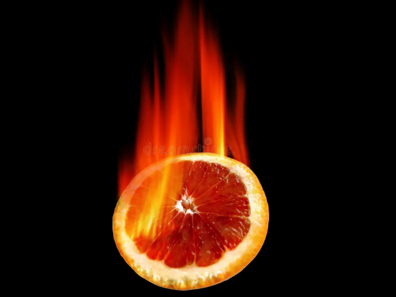 Golden puff pastry cups filled with melted MouCo Boo® cheese, pinwheeled open and topped with caramelized orange zest, sugar, and piri piri spice, lit dramatically against a black background.