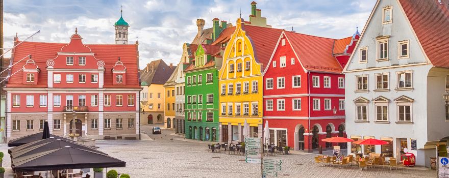 Our History: Colorful buildings in downtown Memmingen—where the local farmers market brings the square to life, though this picture shows the calm days had here too.