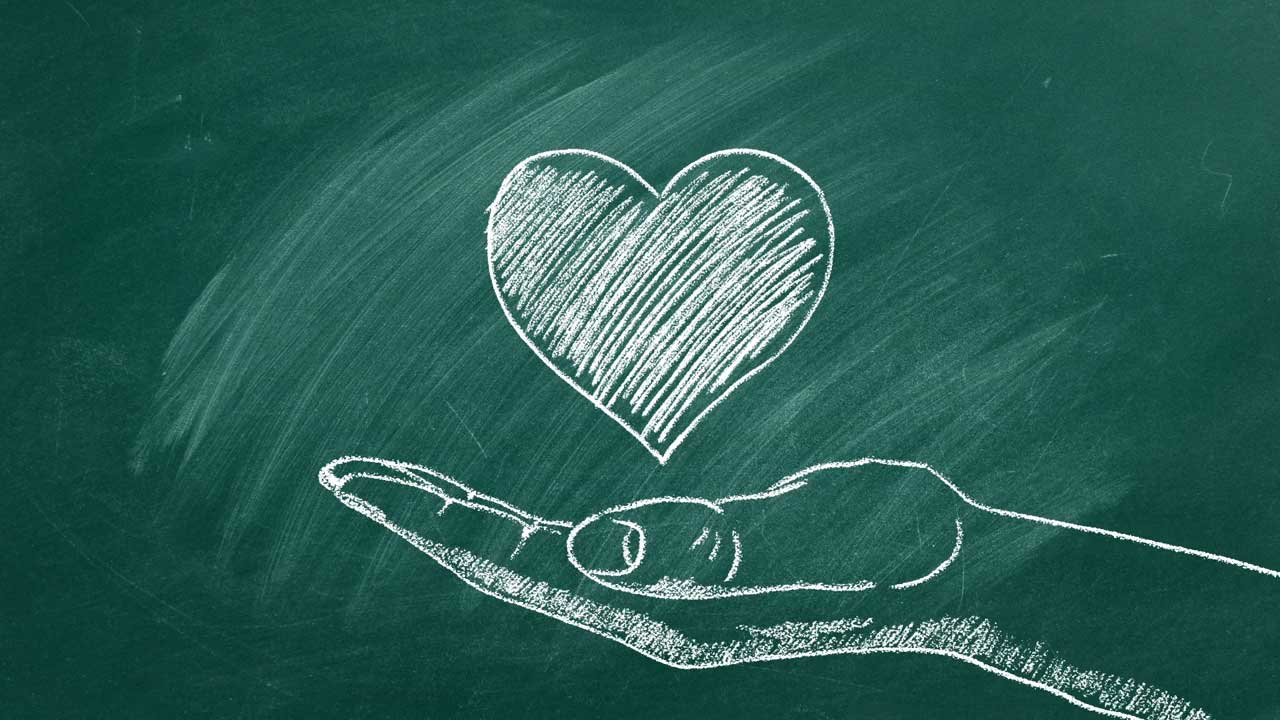 A hand and a heart—symbols used on MouCo’s philanthropy page—capturing the spirit of giving, community, and cheese with heart.