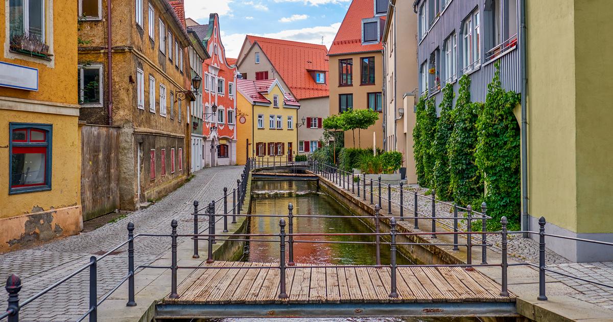 Our History: The little river in Memmingen where the town holds Fischertag—colorful buildings, mossy stones, and old-world charm along the banks.