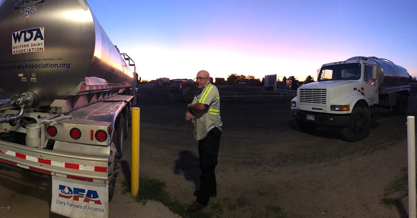 Panoramic view of DFA truck and Chuck the milk truck with DFA driver at sunrise.