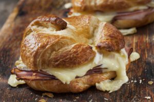 Baked ham and MouCo Camembert croissant sandwiches with Dijon mustard.